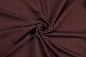 Macro detail of the dark coffee brown fabric texture and fine weaving on the long sleeve dress