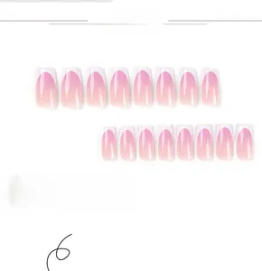 Macro display of 24pcs long coffin press-on nails with pink ombre French tip gradient
