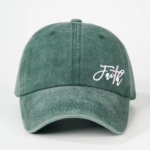 Faded green washed cotton baseball cap featuring Faith embroidery and pink cross