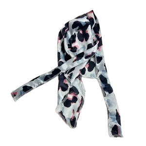 Detail of silk-like leopard print durag showing smooth texture and edge stitching