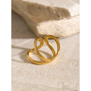 Minimalist 18k gold plated stainless steel intertwined ring on a natural stone base