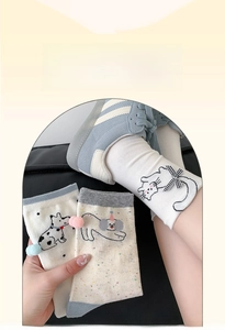 Detail of cotton socks with cartoon animals, cute bow ties and 3D decorative poms