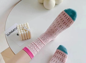 Detail of pink mesh crew socks with contrasting teal toe and ribbed cuffs for summer