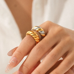 Minimalist croissant style stainless steel ring with two-tone gold finish on a model