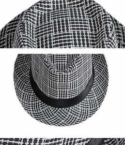 Close-up of black and white woven texture on a straw fedora hat with a silk ribbon detail