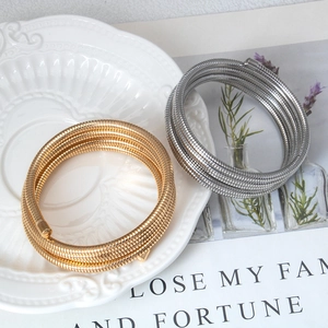 Stackable multi-layer spring bracelets in gold and silver finish for fashion jewelry