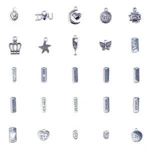 Macro view of assorted silver-tone ocean theme DIY charms and engraved metal pendants