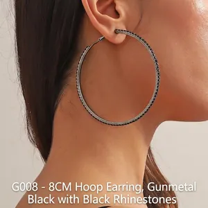 Detail of 8cm gunmetal hoop earrings with black rhinestones worn by a model