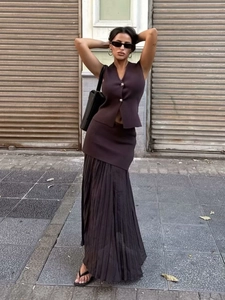 Women's two-piece knit set featuring dark brown V-neck vest and pleated maxi skirt