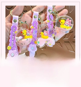 Close-up of liquid quicksand keychains with cartoon charms and glitter sequins