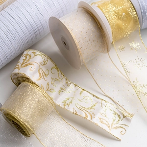 Assorted gold and white Christmas tree ribbons with snowflake patterns for DIY gift wrapping