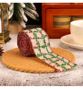 Detail shot showing festive Christmas ribbon with green leaf and red berry patterns