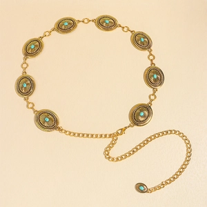 Detail of vintage golden metal waist chain with turquoise stones and sunburst texture