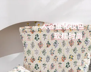 Close-up of quilted floral makeup bag featuring soft diamond stitching and flower pattern