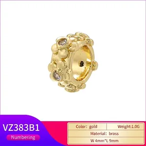 Golden flower brass spacer bead with cubic zirconia stones measuring 4mm by 9mm