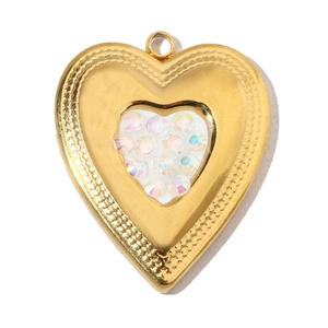 Macro detail of golden heart pendant with iridescent zircons and textured metal edge