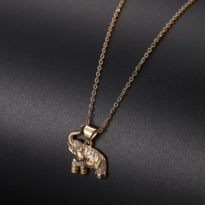 Close-up of golden elephant pendant encrusted with white zircon stones on a fine chain