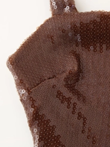 Detailed macro view of brown sequin fabric texture on a backless evening dress