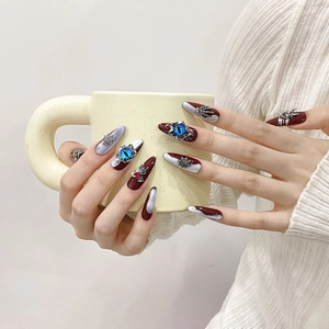 Handmade press-on nails with 3D evil eye and spider web gothic charms on long almond tips