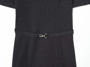 Close-up of charcoal gray dress belt with silver metal clasp and brushed fabric texture