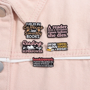 Detail of five enamel reading pins and coffee badges on pink denim jacket pocket