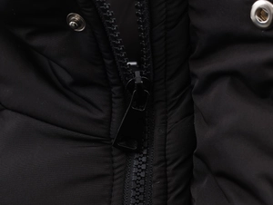 Detail view showing black plastic zipper and metal snap buttons on a padded jacket