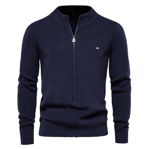 Detail of navy knit cardigan showing metal zipper and vertical ribbed texture