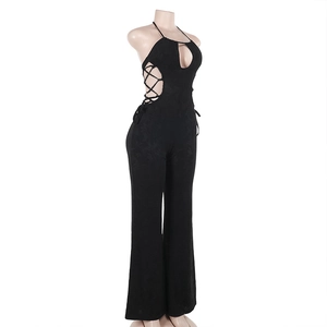 Detail of black halter neck jumpsuit featuring criss-cross side lace-up and waist cut-out
