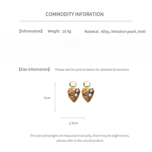 Size information and details of vintage heart earrings with pearls and gold alloy finish