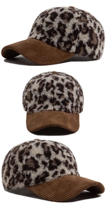 Detailed view of leopard print plush fabric and brown corduroy brim on a baseball cap