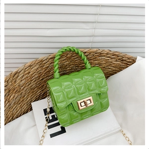 Detail of green jelly bag with quilted pattern, gold metal twist lock and chain strap