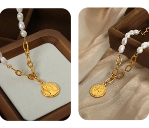 Macro detail of freshwater pearl necklace with vintage gold coin pendant on silk