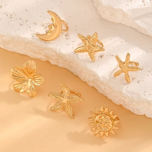 Bohemian gold celestial ear cuff set featuring sun moon and star shapes on marble