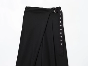 Detail view of black blend trousers featuring silver metal buckles and decorative eyelets