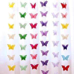 Multi-colored 3D paper butterfly garlands hanging in rows for party decoration