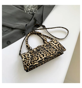 Detailed view of leopard print PU leather crossbody bag with dual top handles and long strap