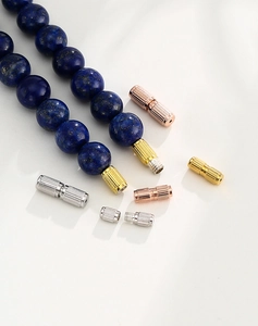 Detailed macro view of spiral screw clasps for DIY jewelry in gold and silver finishes