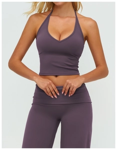 Detail of the high-waisted leggings and halter V-neck sports bra in brushed purple fabric
