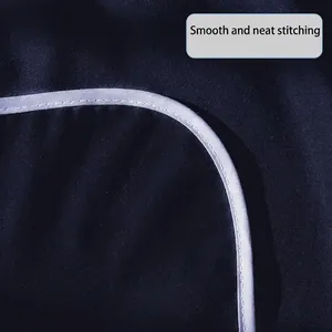 Waterproof adult bib in navy blue with reinforced light gray piping and smooth stitching