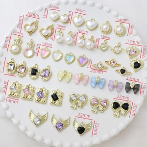 Detail view of alloy jewelry pendants with pearls and zircon on a size grid tray