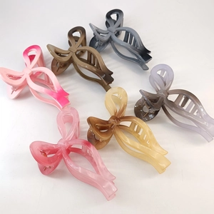 Detailed set of 13cm oversized bow claw clips in six varied colors on a white background