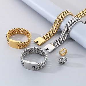 Detailed shot of silver and gold Cuban link bracelets and rings in a high-quality set