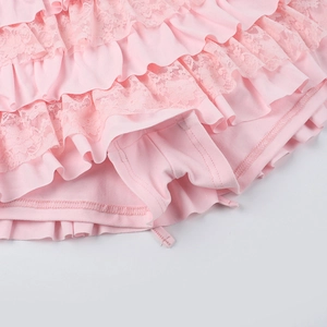 Detail of pink tiered lace ruffles and built-in safety lining on mini dress