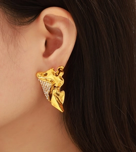 Close-up of gold irregular pleated wing earrings with micro-inlaid diamonds on model ear