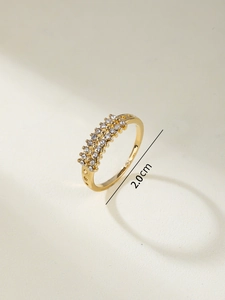 Detail view of gold-tone ring with three rows of clear zircons and 2.0cm diameter