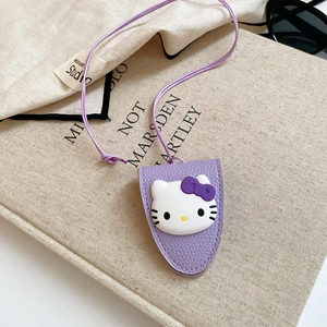 Detail of purple litchi grain leather key case with cute cartoon cat character and lanyard