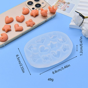DIY silicone mold for moon and star shapes with finished resin crafts on blue surface