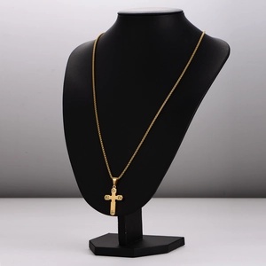 Gold stainless steel necklace with engraved cross pendant on a professional black bust