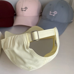 Detail of adjustable silver metal buckle on the back of the cotton cartoon puppy cap