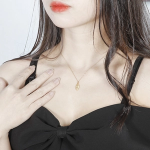 Vintage oval Virgin Mary pendant necklace in gold titanium steel shown on model